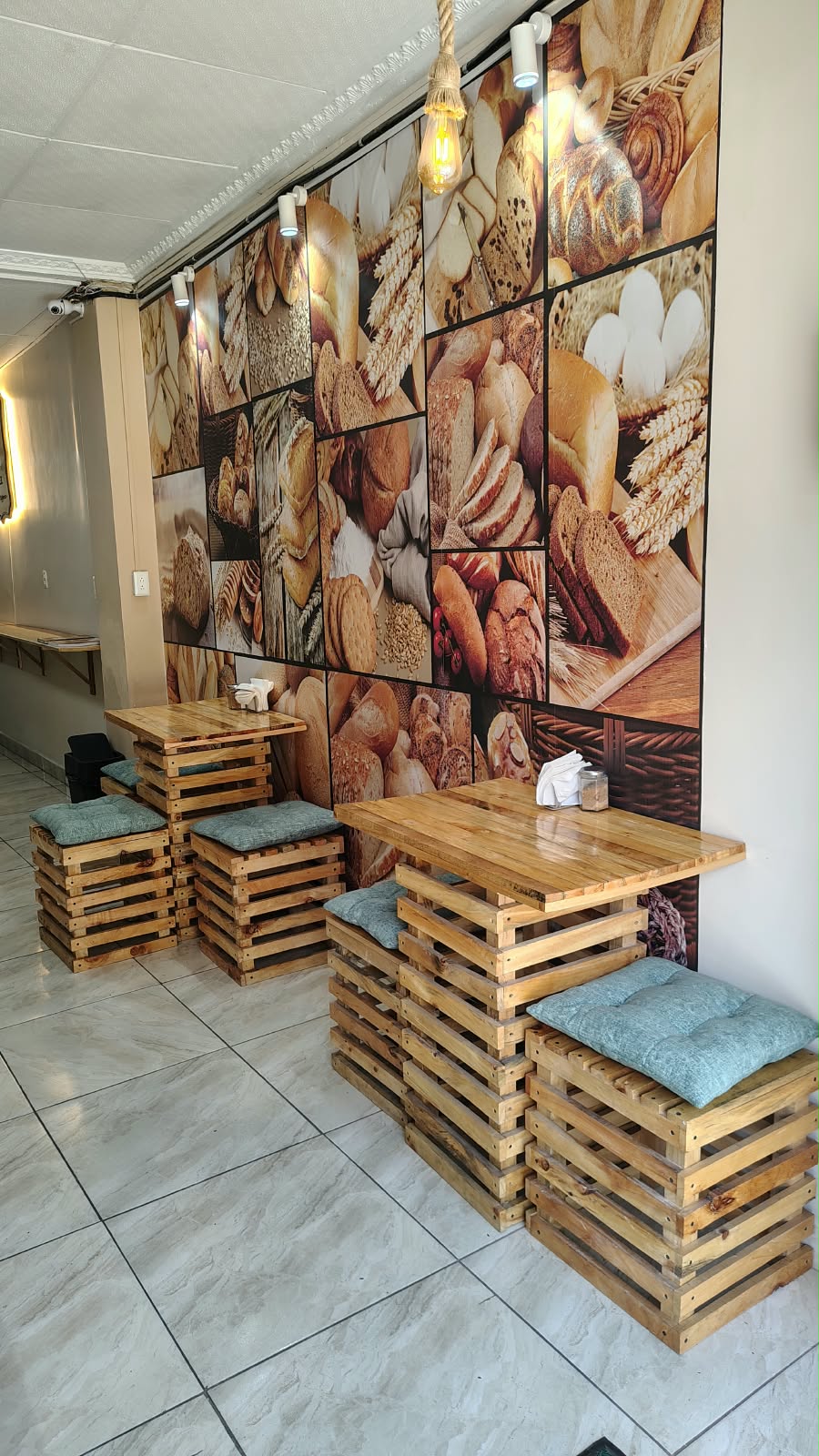 Mural de panes con mesas y asientos de palés de madera